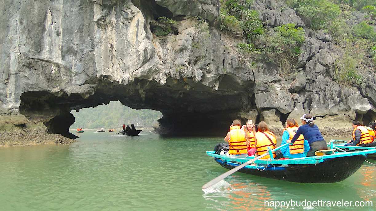 Picture showing Bamboo boat tour in Ha Long Bay under Limestone arches