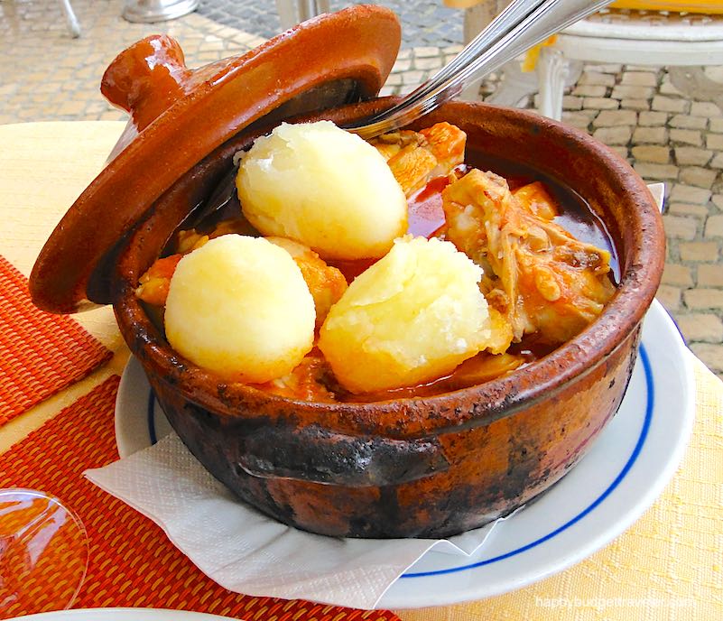 Picture of chicken cooked in a clay pot with carrots and potatoes