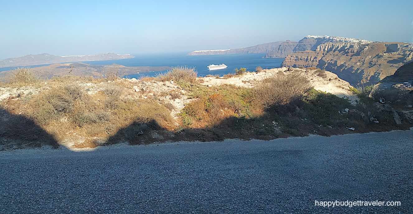 Picture of a panoramic view of Thera to the right and Oia in the middle of the picture from the road to Athinios Port, Athinios, Santorini